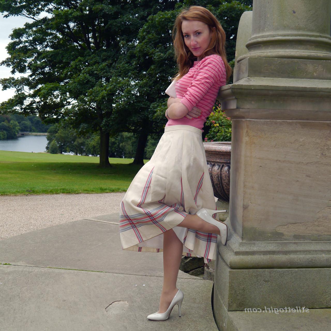 15P Cute redhead babe poses in a pair of lovely white high heeled stilettos for all 