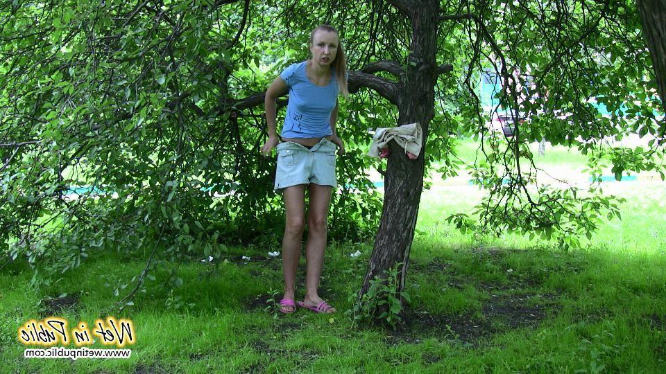 14P Gal with long ponytail spreading and wetting herself on a garden bench