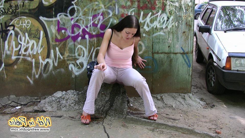 10P Longhaired amateur desperate to pee wets her pants and the asphalt