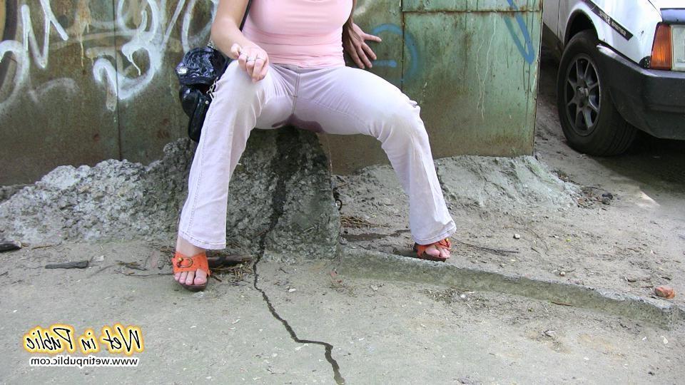 10P Longhaired amateur desperate to pee wets her pants and the asphalt