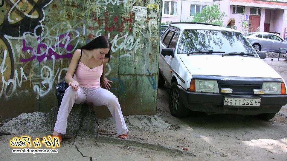 10P Longhaired amateur desperate to pee wets her pants and the asphalt