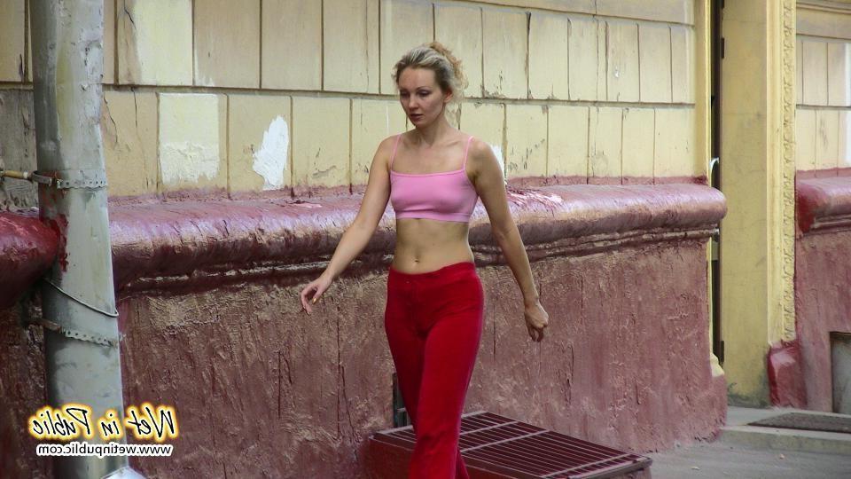 16P Cutie hides behind a truck to pee right through her red sporty pants
