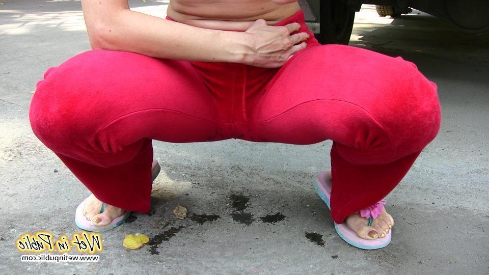 16P Cutie hides behind a truck to pee right through her red sporty pants