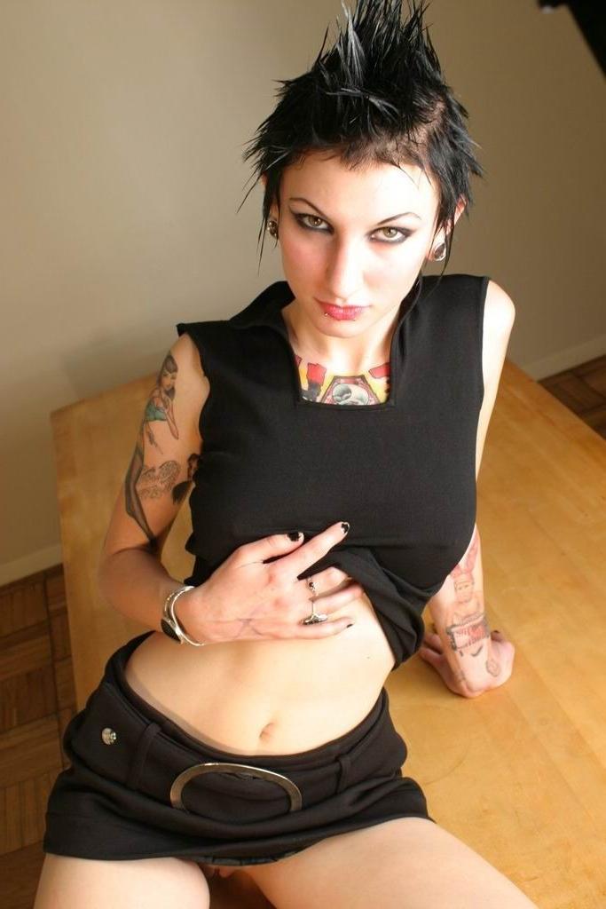 16P Naughty goth brunette shows off her body piercings and tattoos