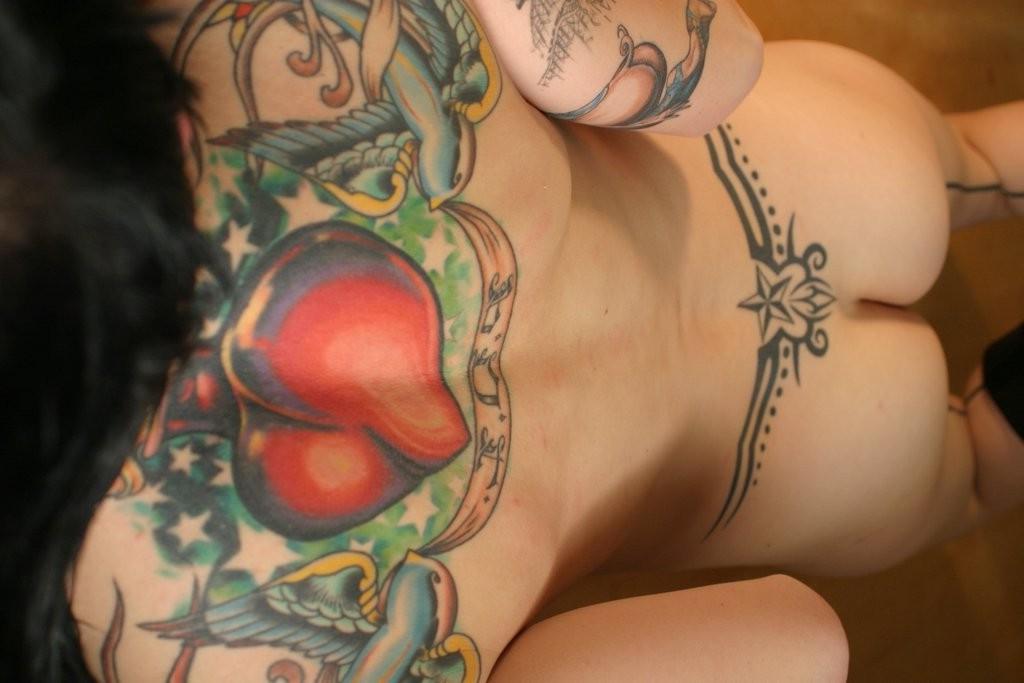 16P Naughty goth brunette shows off her body piercings and tattoos