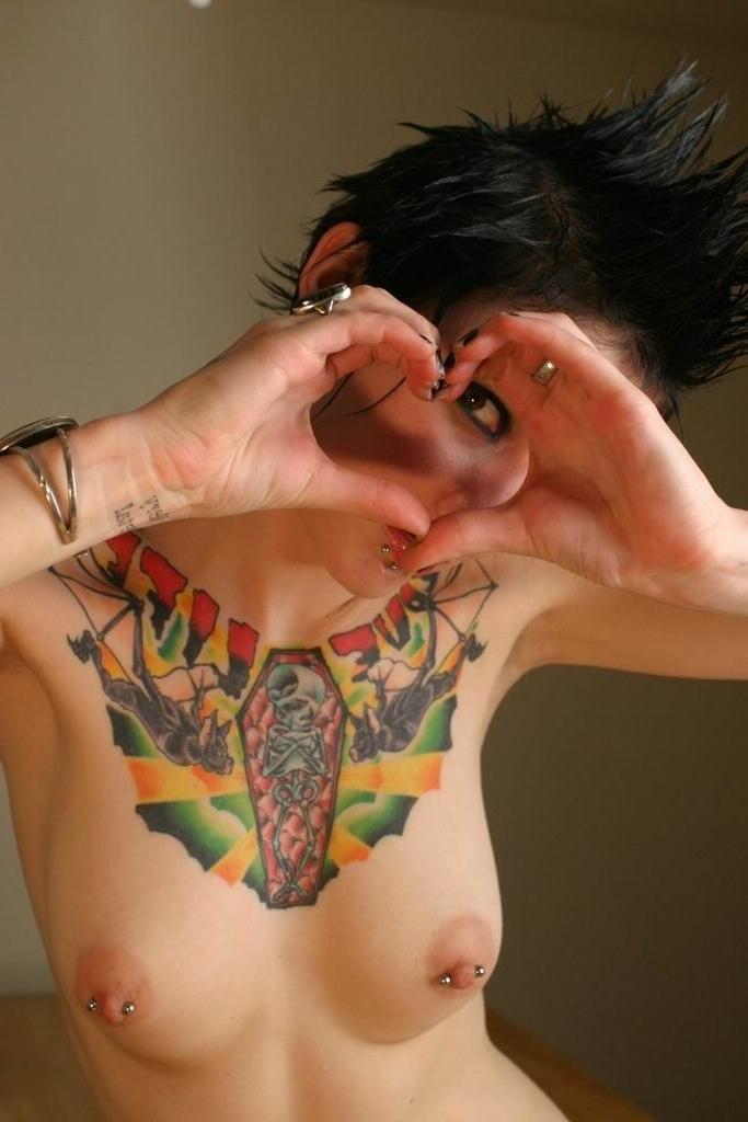 16P Naughty goth brunette shows off her body piercings and tattoos