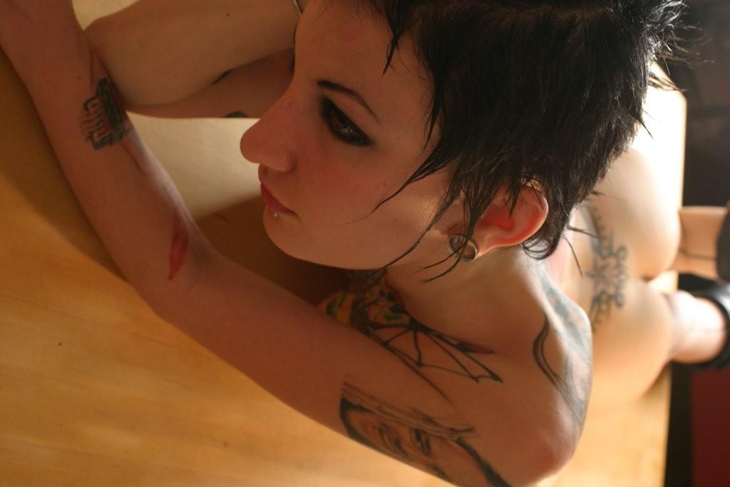 16P Goth chick displays her collection of sexy piercings and tattoos