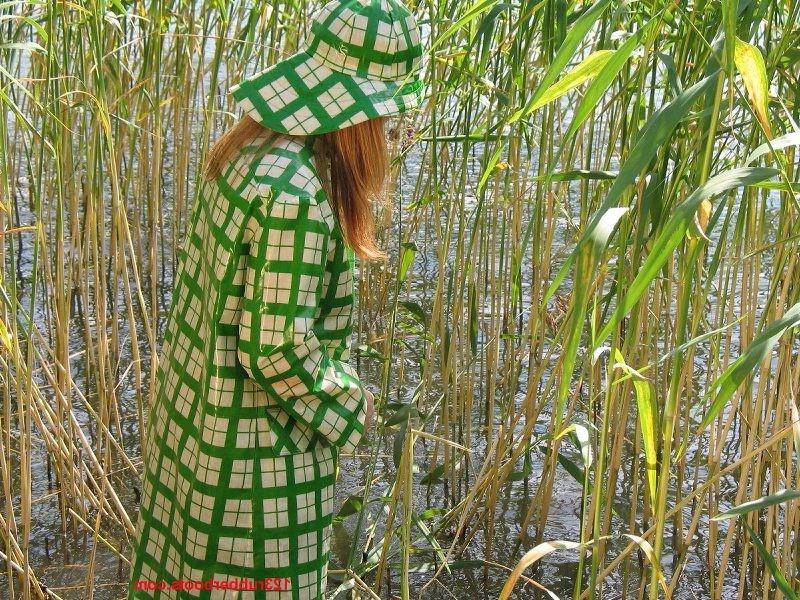 20P Girl in green rainwear and fishermans rubber boots