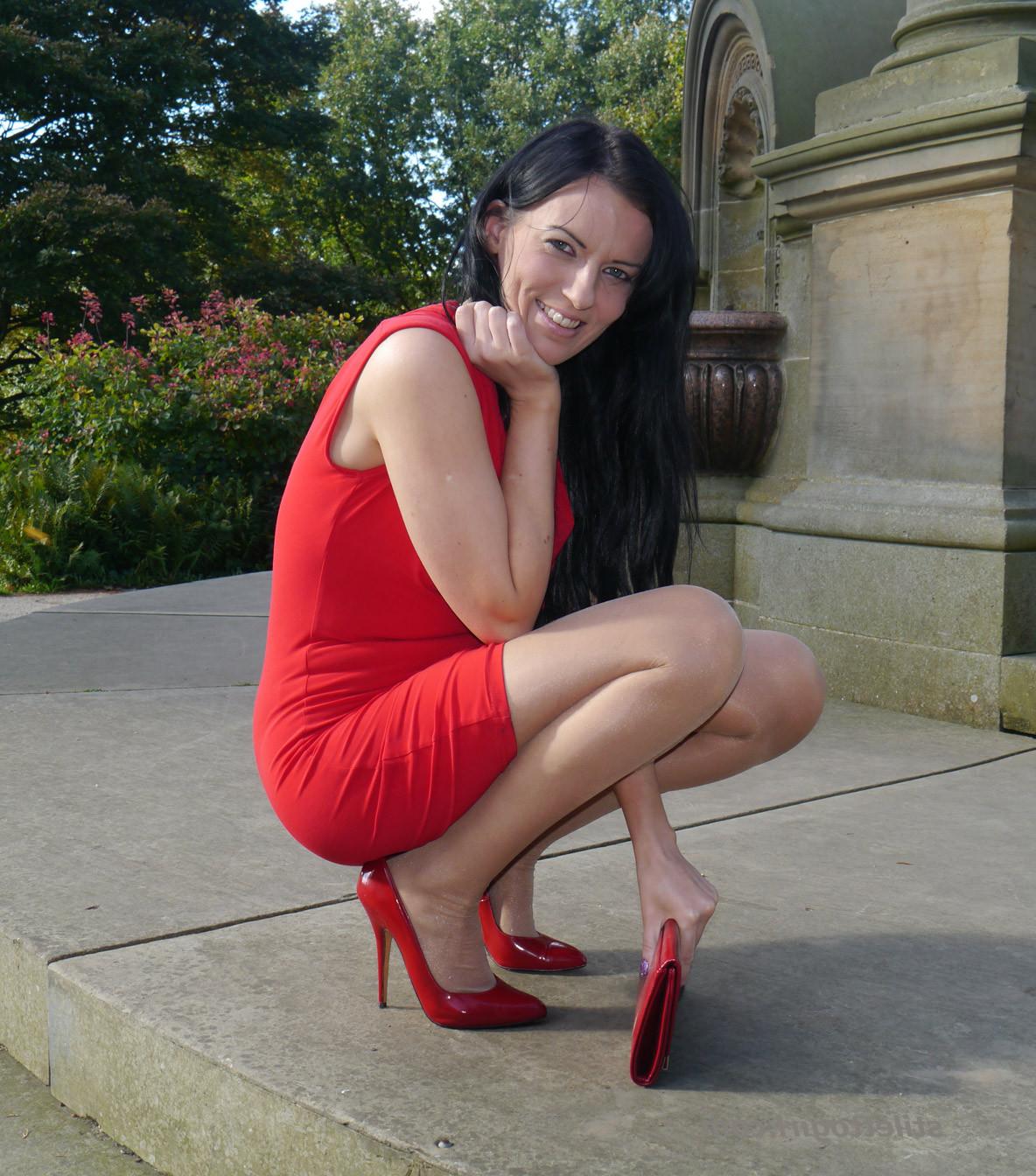12P Sexy babe with shoe fetish takes a stroll outdoors wearing a tight red dress wit
