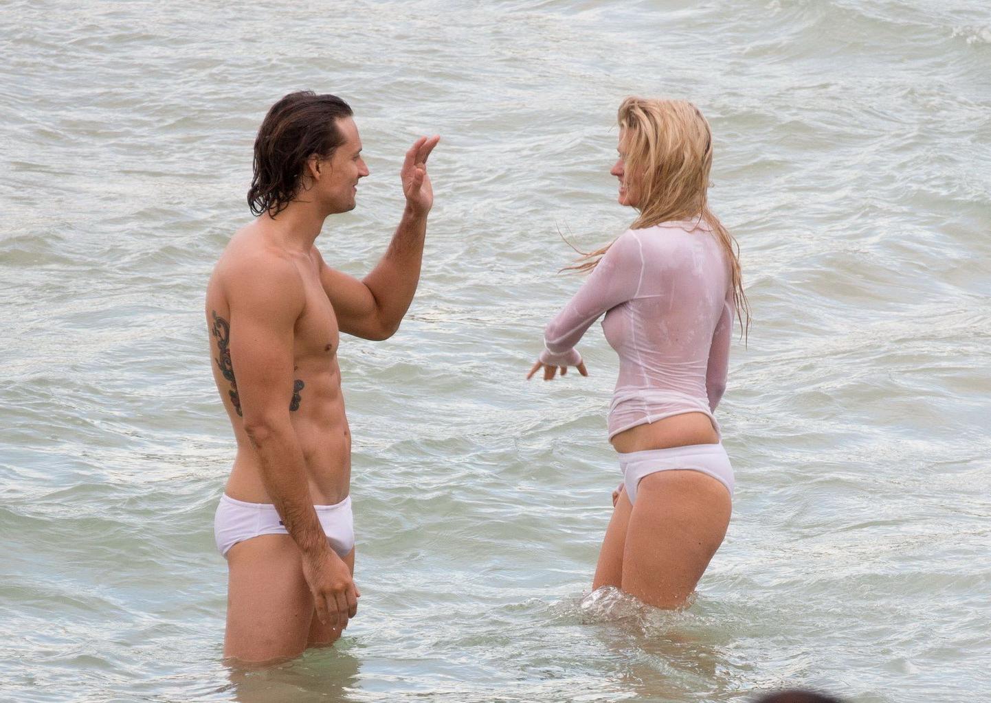 16P Lara Stone showing boobs in wet top and bikini bottom