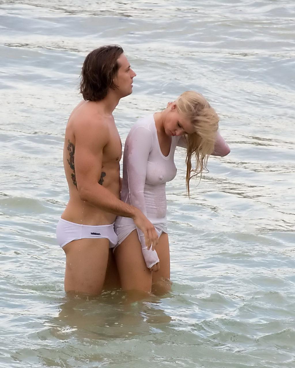 16P Lara Stone showing boobs in wet top and bikini bottom