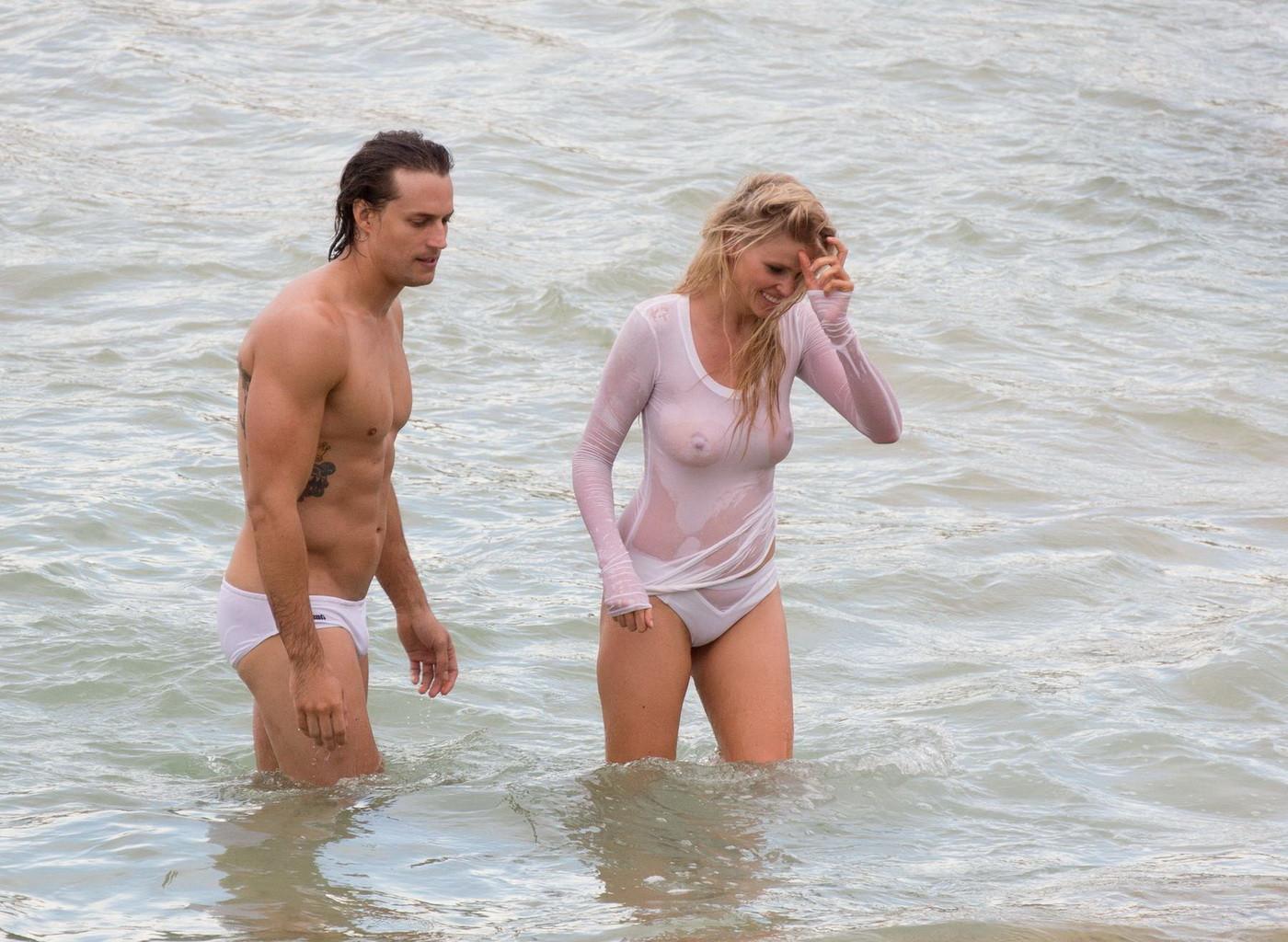 16P Lara Stone showing boobs in wet top and bikini bottom