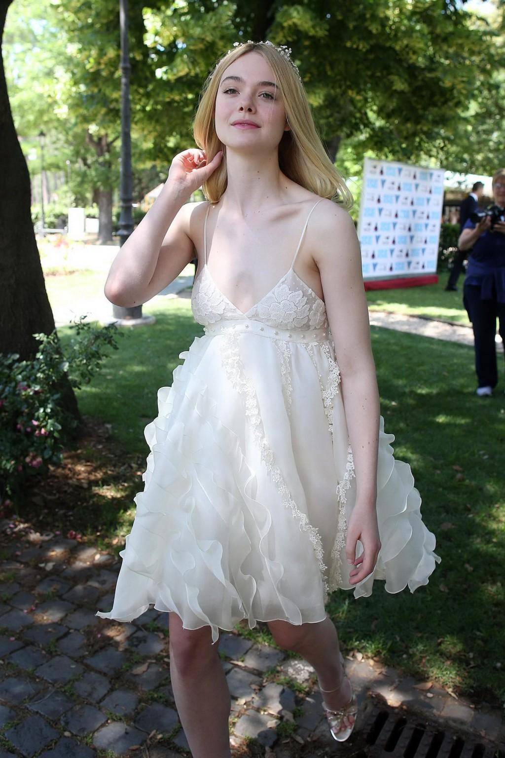 15P Elle Fanning cleavy and leggy in white lace dress