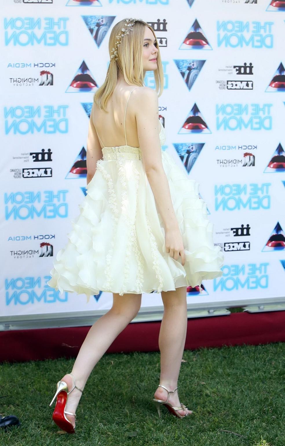 15P Elle Fanning cleavy and leggy in white lace dress