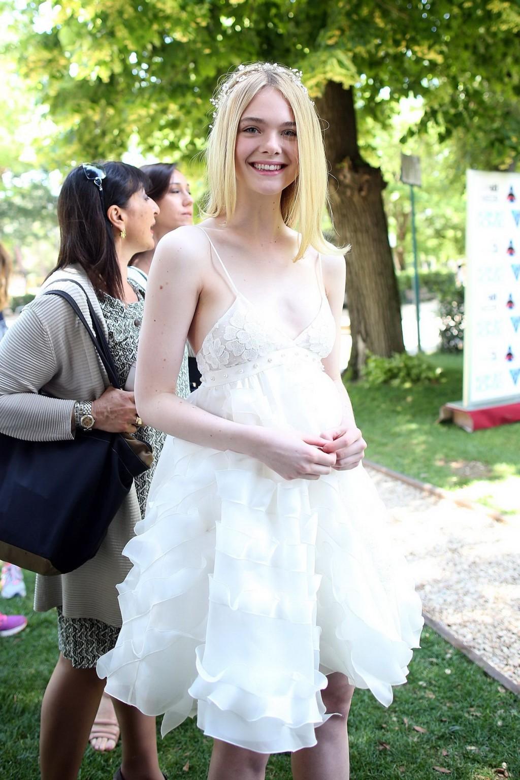 15P Elle Fanning cleavy and leggy in white lace dress