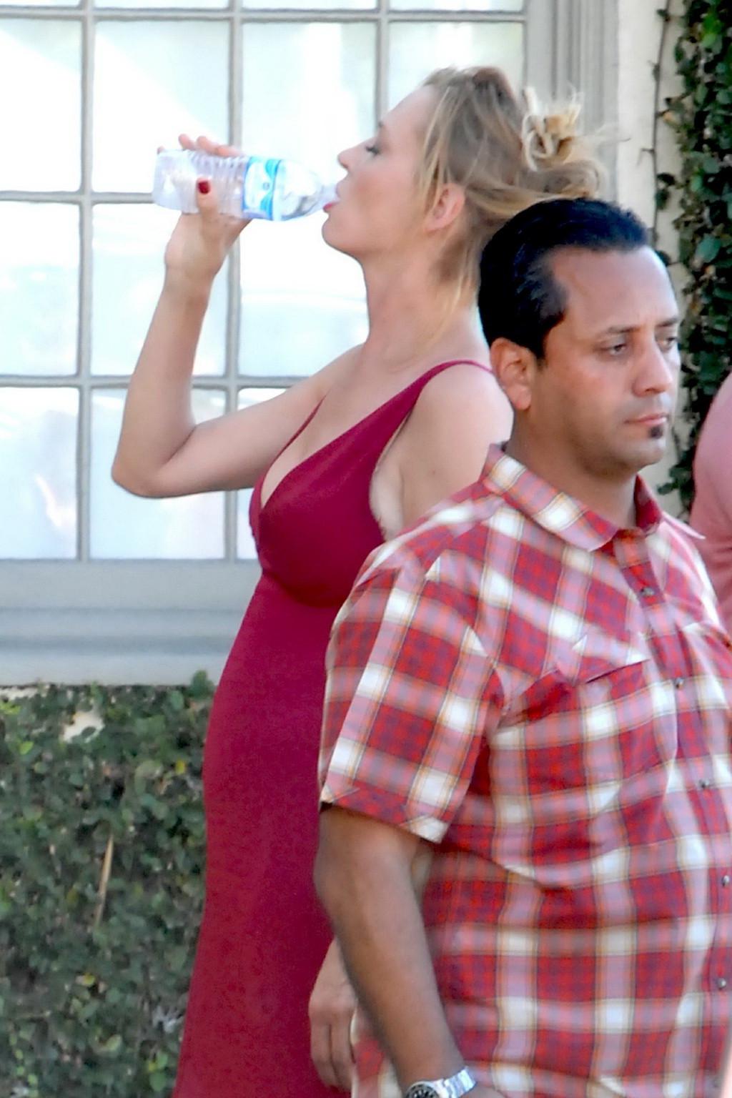 16P Uma Thurman showing huge cleavage on the set