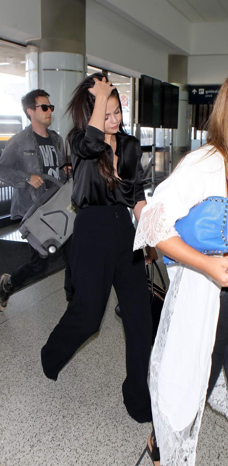 16P Selena Gomez showing huge cleavage in a wide open shirt