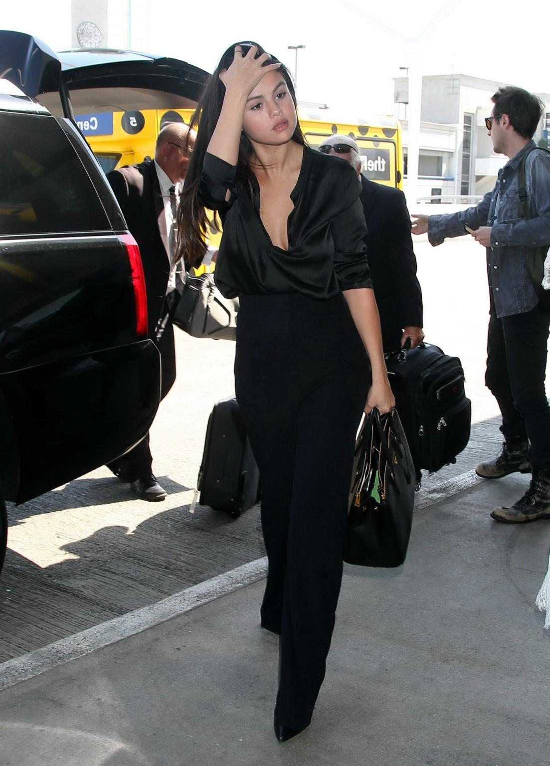16P Selena Gomez showing huge cleavage in a wide open shirt