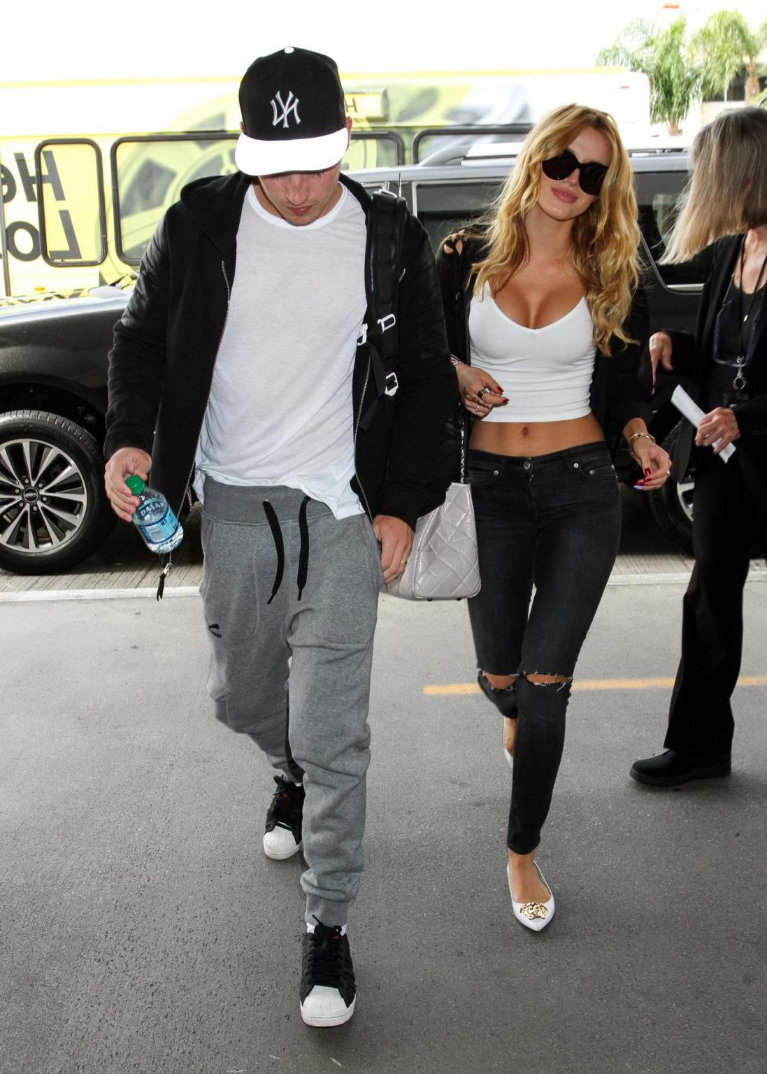 16P Bella Thorne shows huge cleavage wearing white crop top at LAX