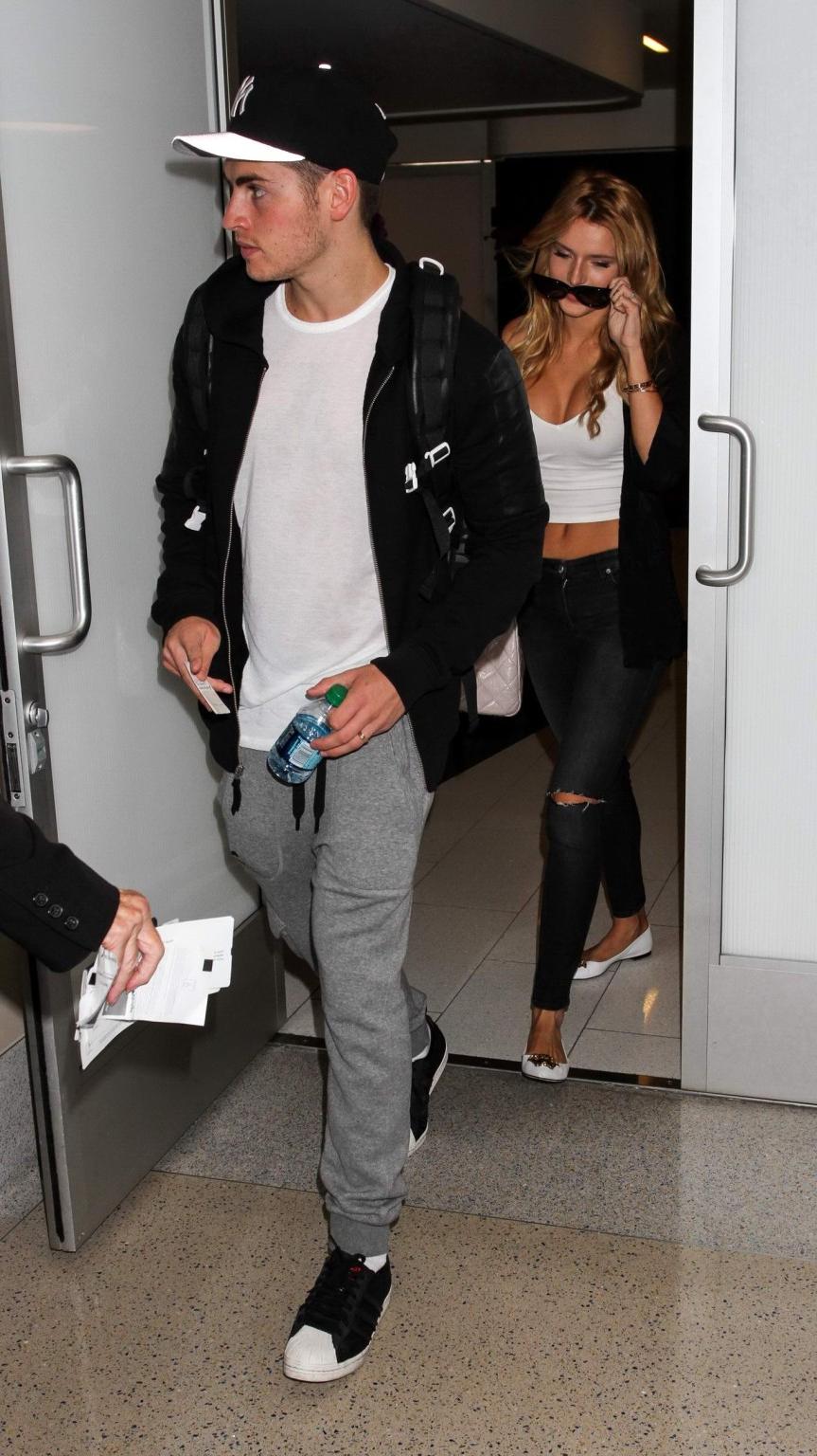 16P Bella Thorne shows huge cleavage wearing white crop top at LAX
