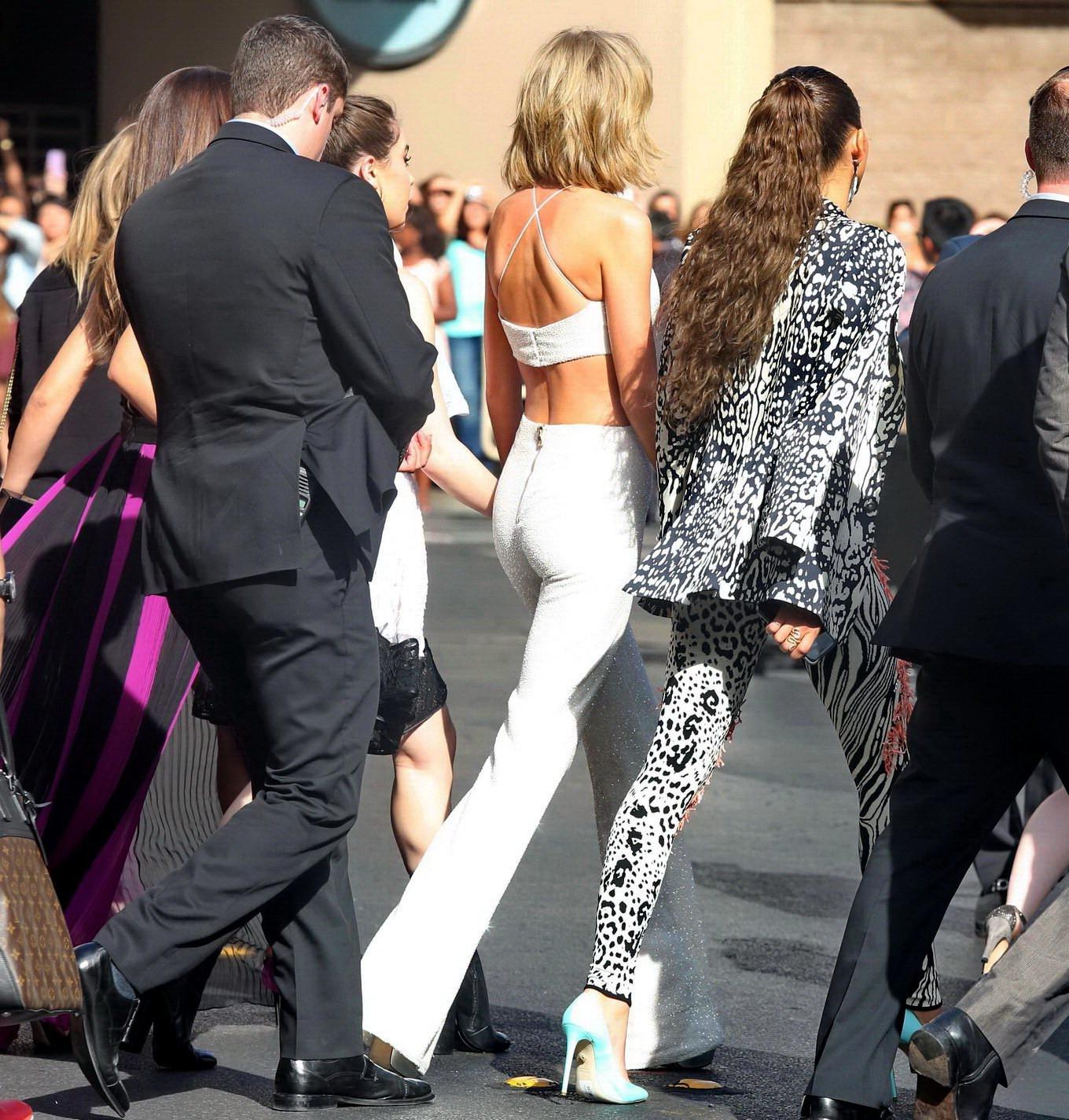 16P Taylor Swift shows off her ass and huge cleavage wearing a white jumpsuit at the