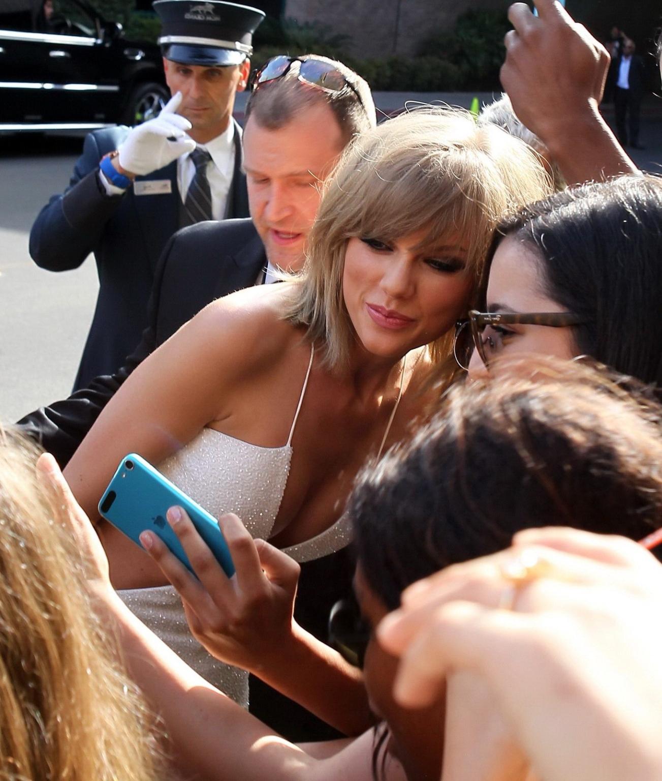 16P Taylor Swift shows off her ass and huge cleavage wearing a white jumpsuit at the