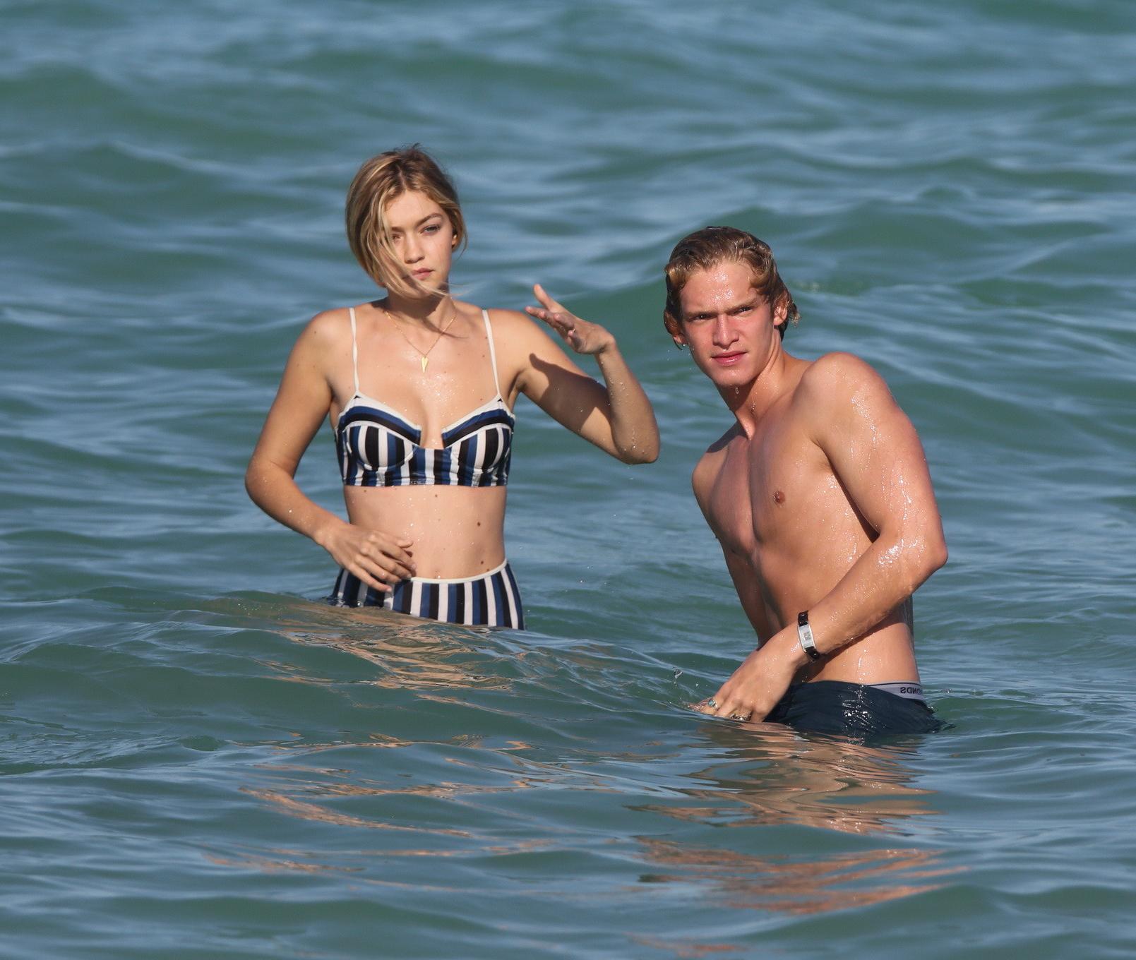 16P Gigi Hadid showing off her hot body in a striped retro bikini at Miami Beach