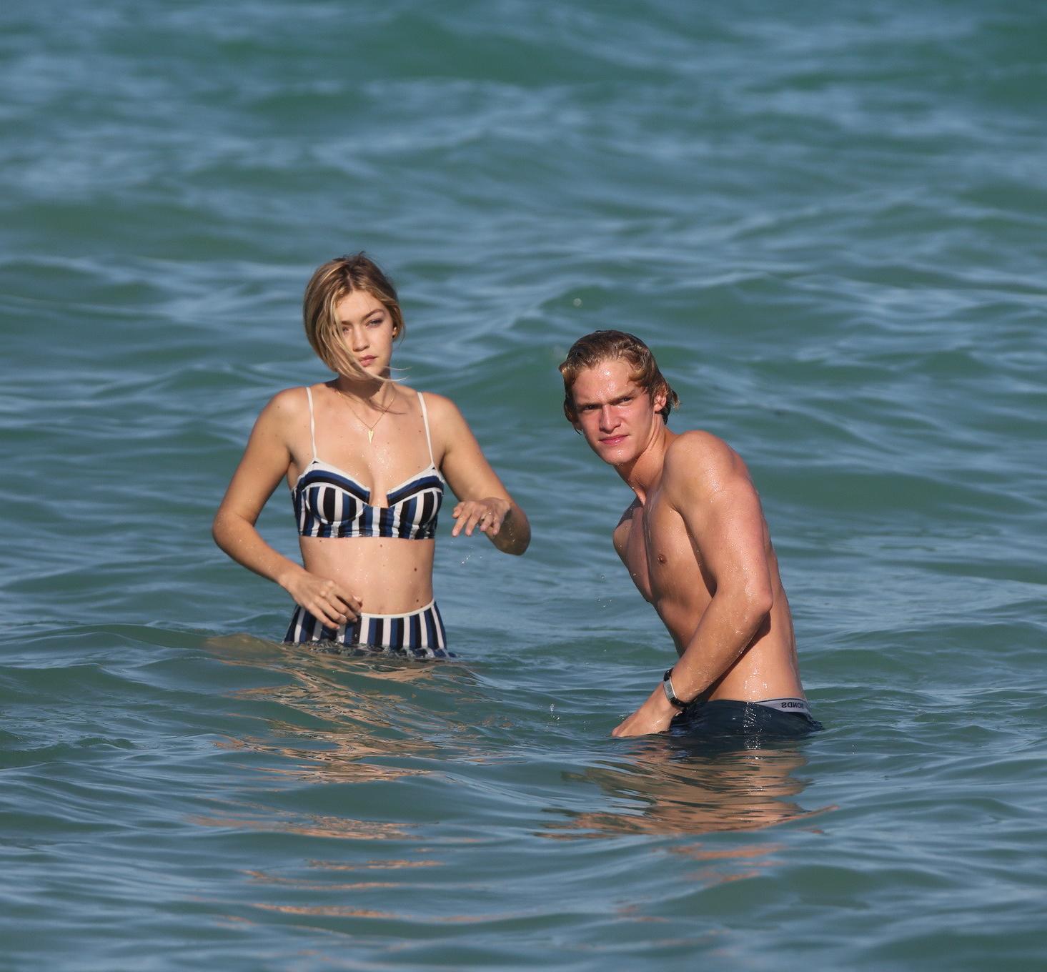 16P Gigi Hadid showing off her hot body in a striped retro bikini at Miami Beach