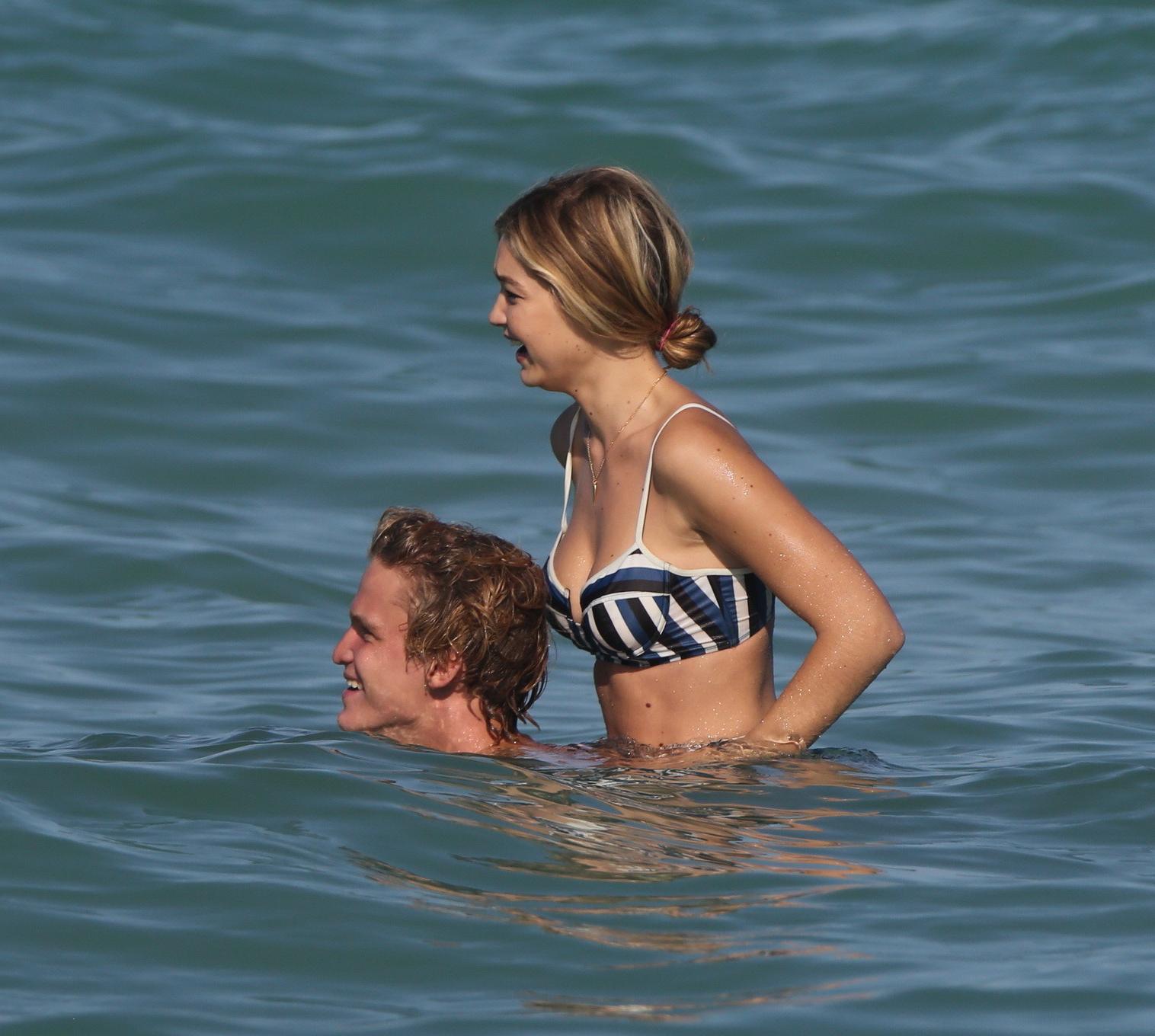 16P Gigi Hadid showing off her hot body in a striped retro bikini at Miami Beach