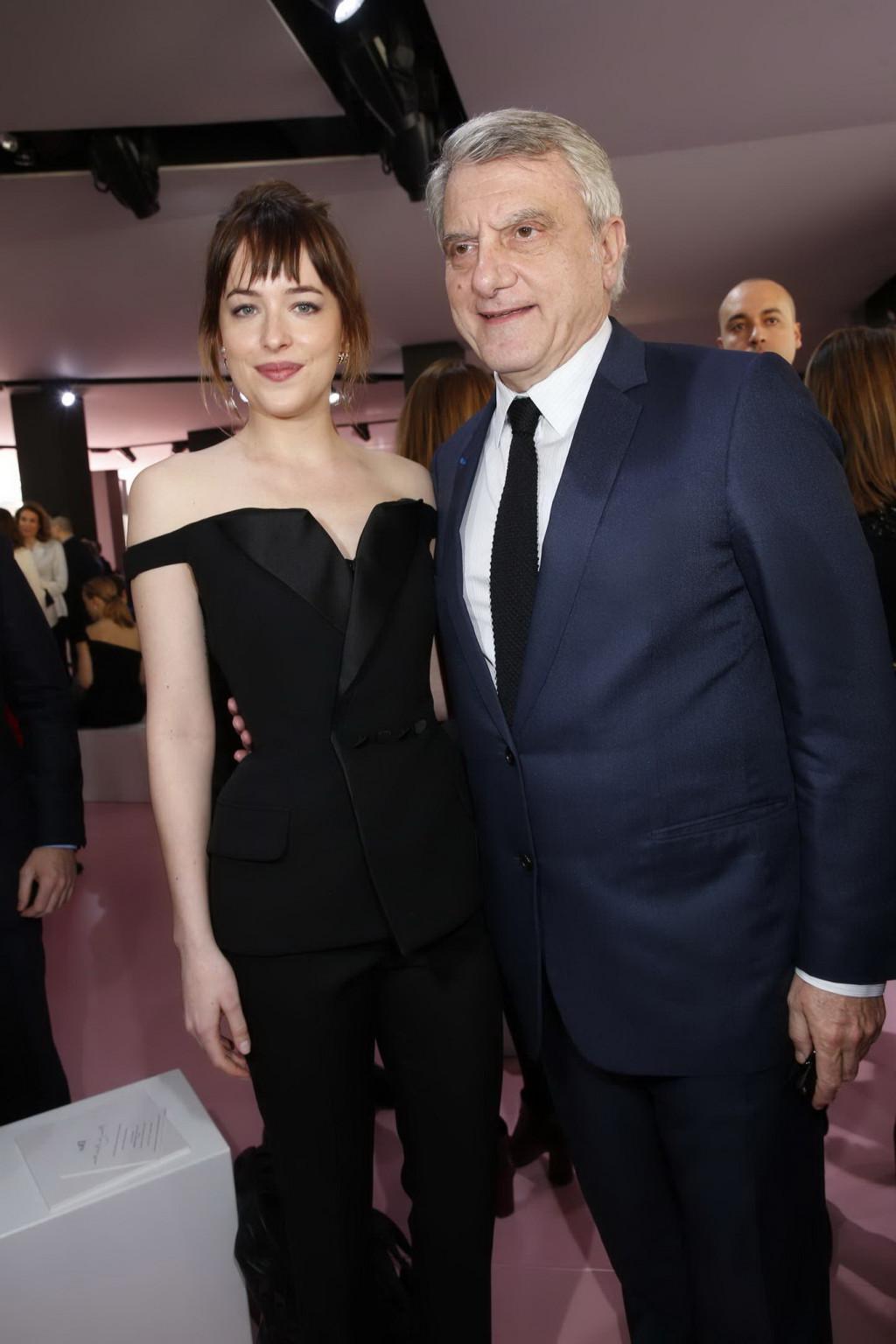 16P Dakota Johnson showing big cleavage in black jumpsuit at Christian Dior Fashion 