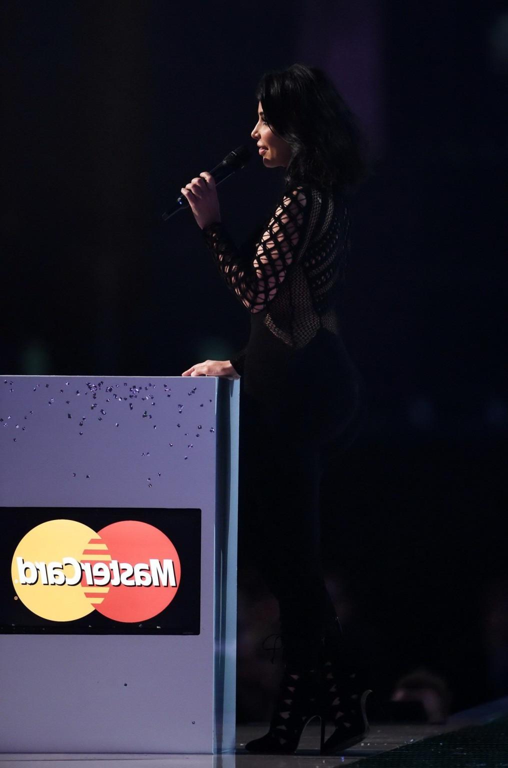 16P Kim Kardashian nip slip wearing a mesh jumpsuit at the BRIT Awards Arrivals and 