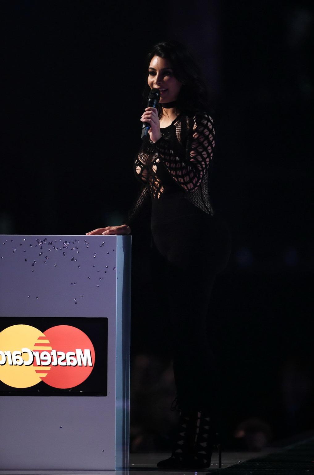 16P Kim Kardashian nip slip wearing a mesh jumpsuit at the BRIT Awards Arrivals and 