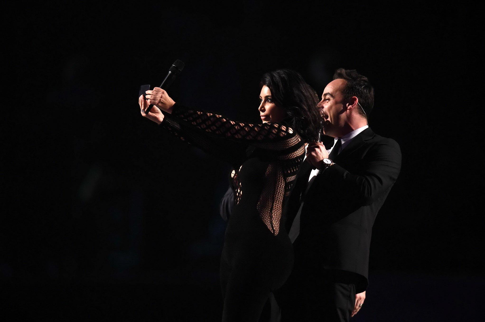 16P Kim Kardashian nip slip wearing a mesh jumpsuit at the BRIT Awards Arrivals and 