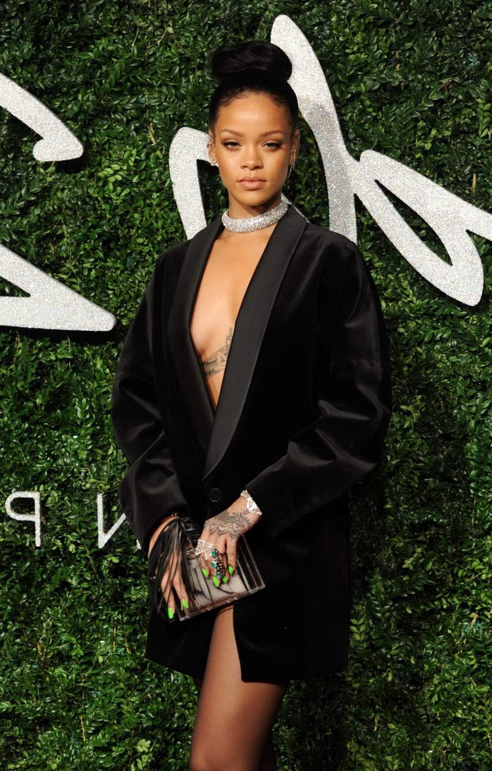 16P Rihanna braless showing cleavage at the British Fashion Awards in London