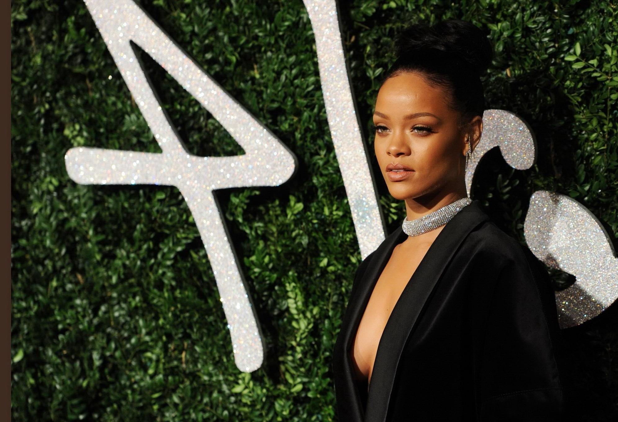 16P Rihanna braless showing cleavage at the British Fashion Awards in London