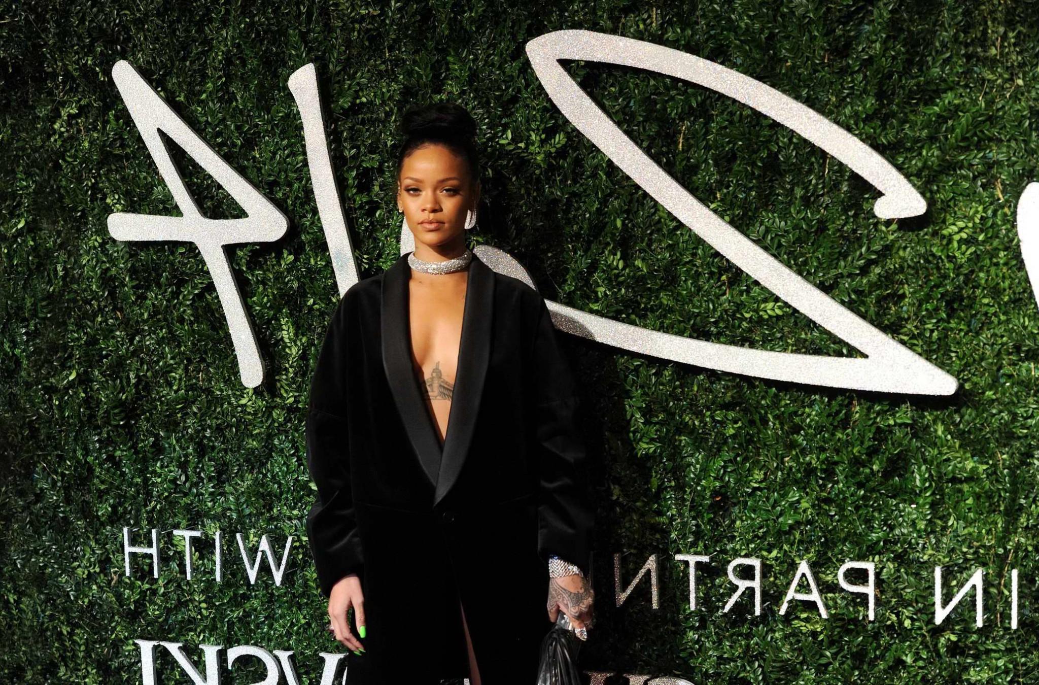 16P Rihanna braless showing cleavage at the British Fashion Awards in London