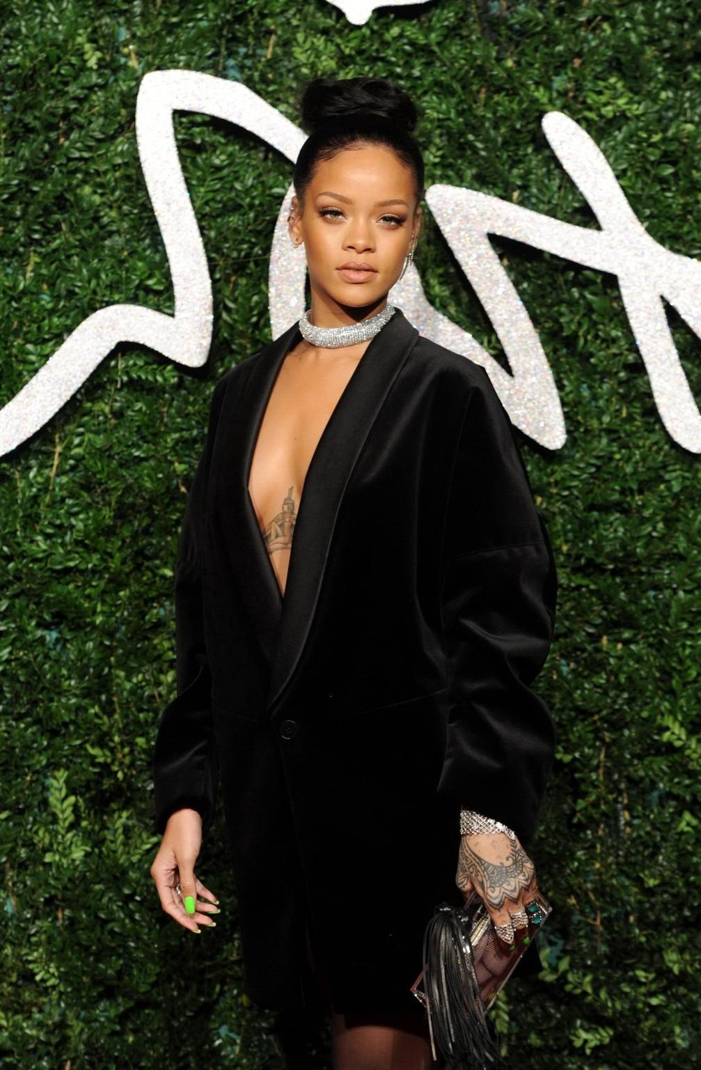 16P Rihanna braless showing cleavage at the British Fashion Awards in London