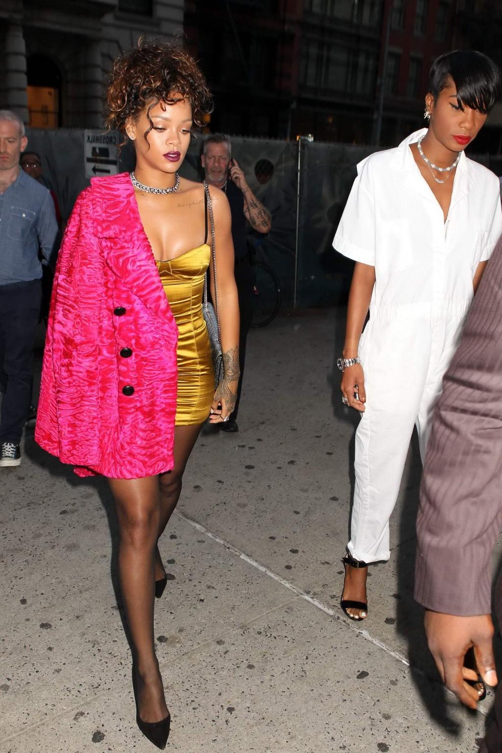 16P Rihanna shows cleavage and legs wearing a little yellow dress outside Nobu resta