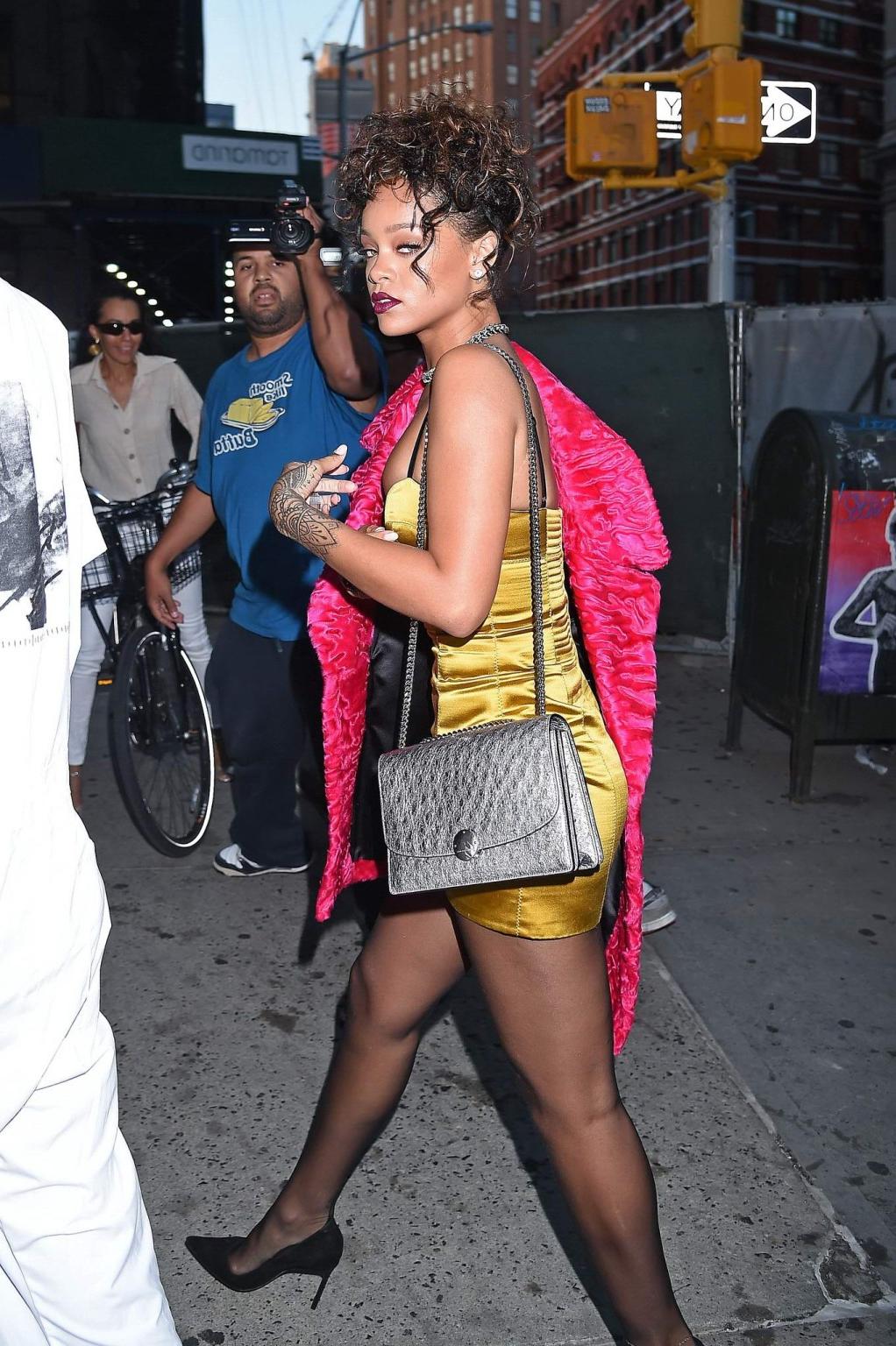16P Rihanna shows cleavage and legs wearing a little yellow dress outside Nobu resta