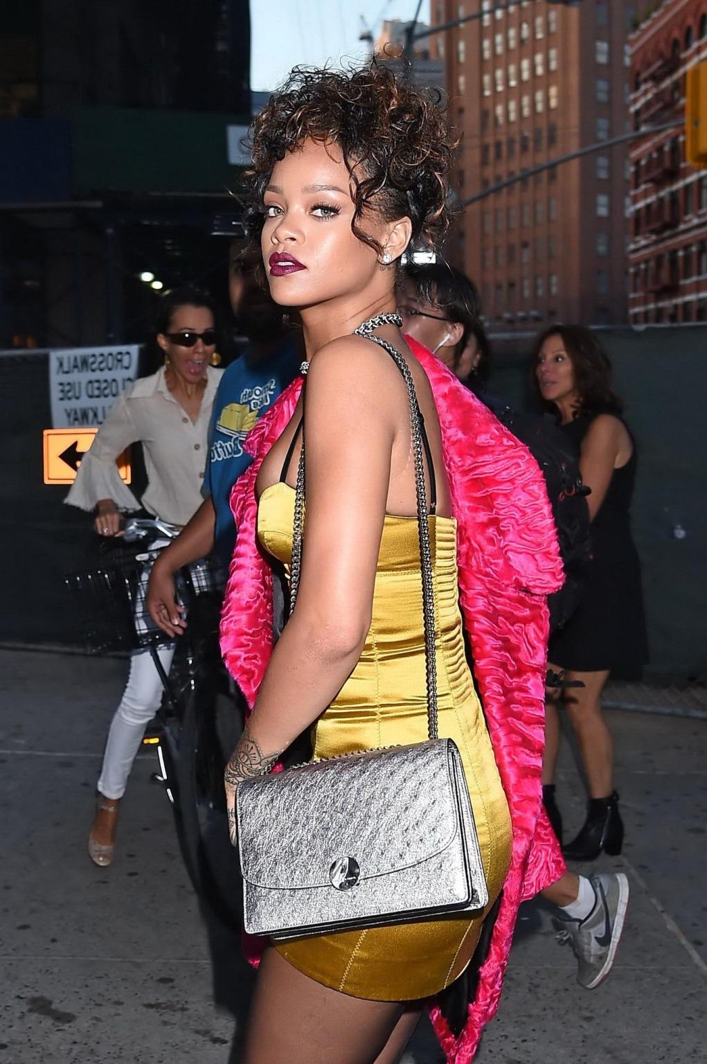 16P Rihanna shows cleavage and legs wearing a little yellow dress outside Nobu resta