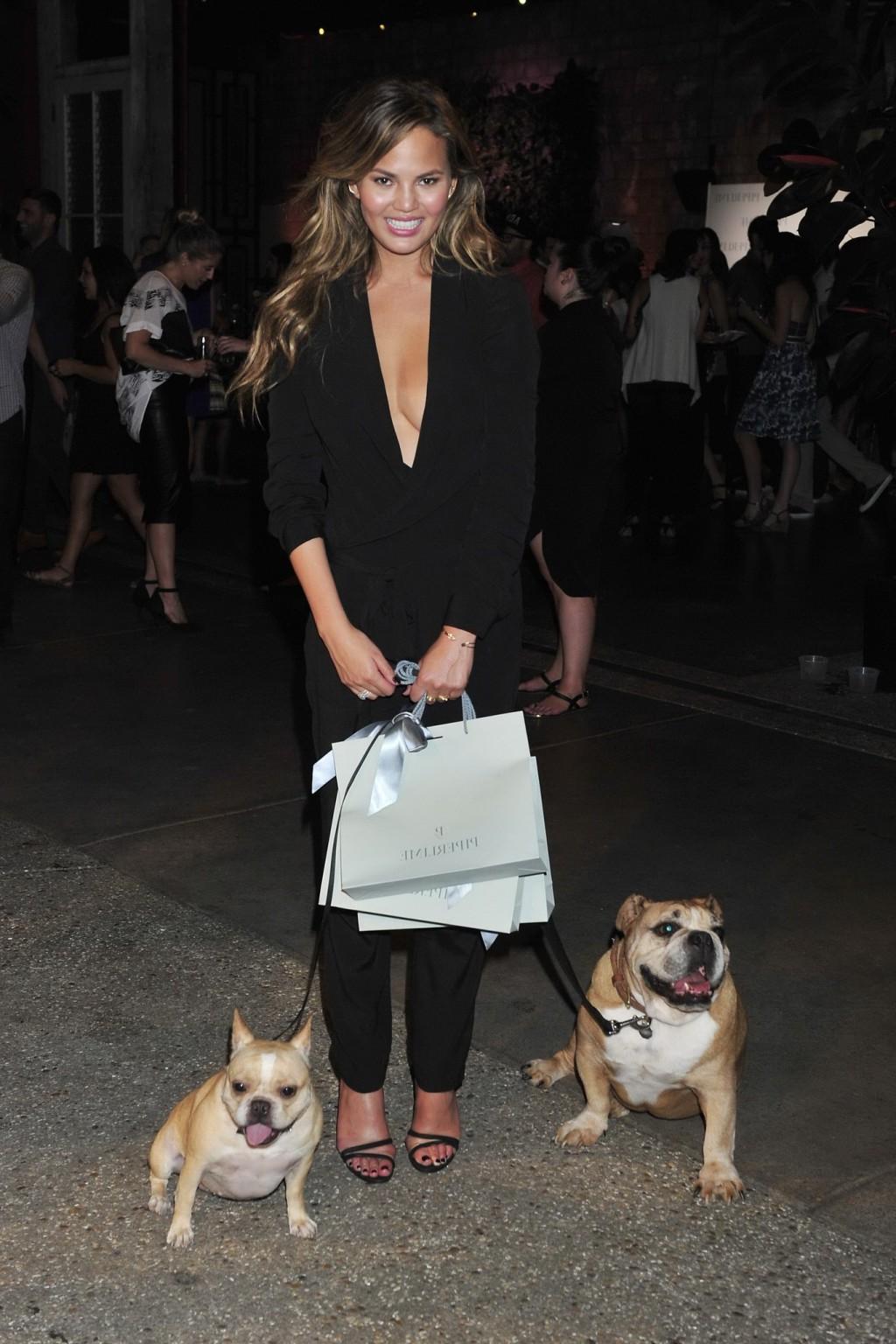 10P Chrissy Teigen braless  cleavy petting two ugly bulldogs at the new Piperlime co