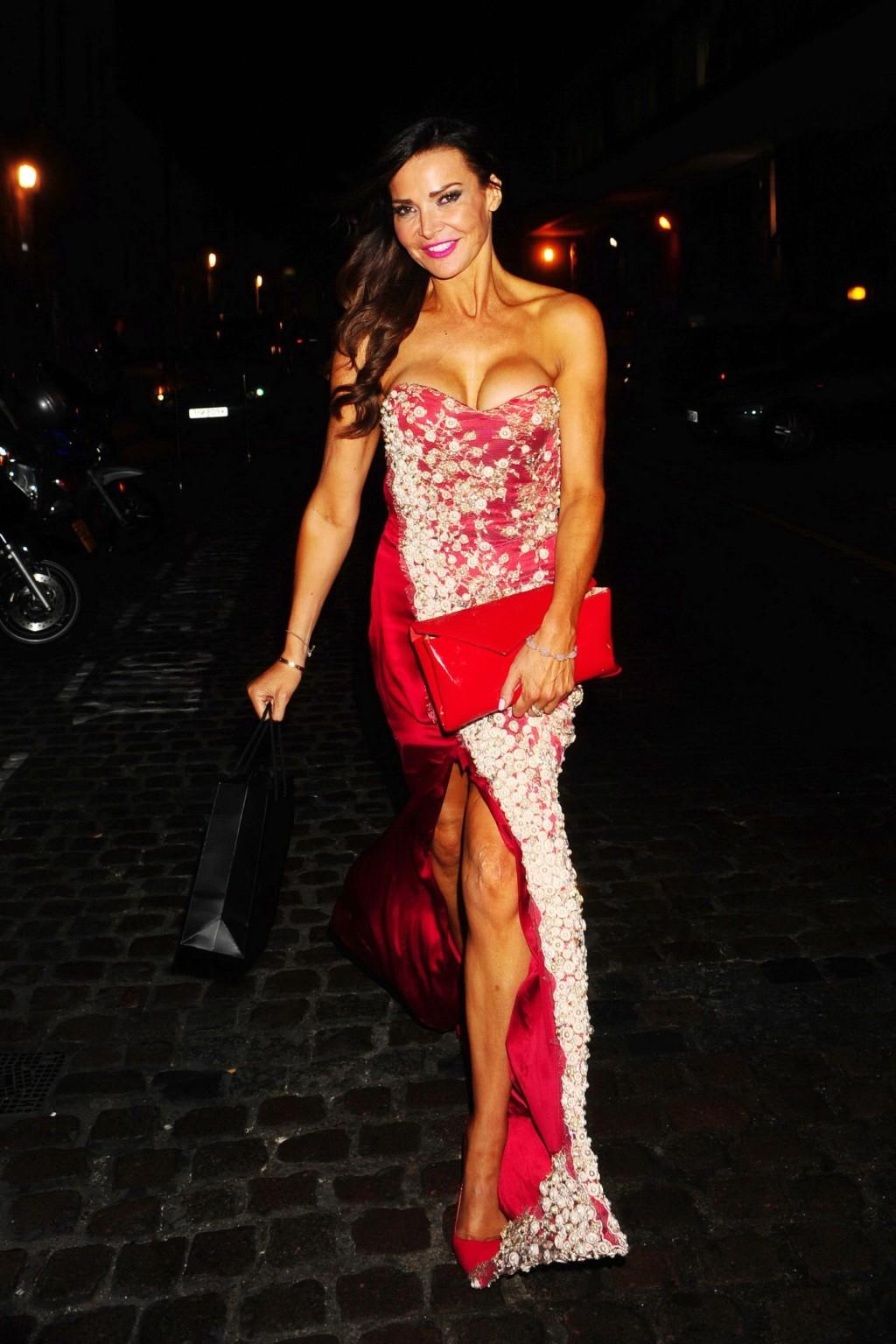 16P Lizzie Cundy shows huge cleavage wearing a strapless dress outside The Chiltern 