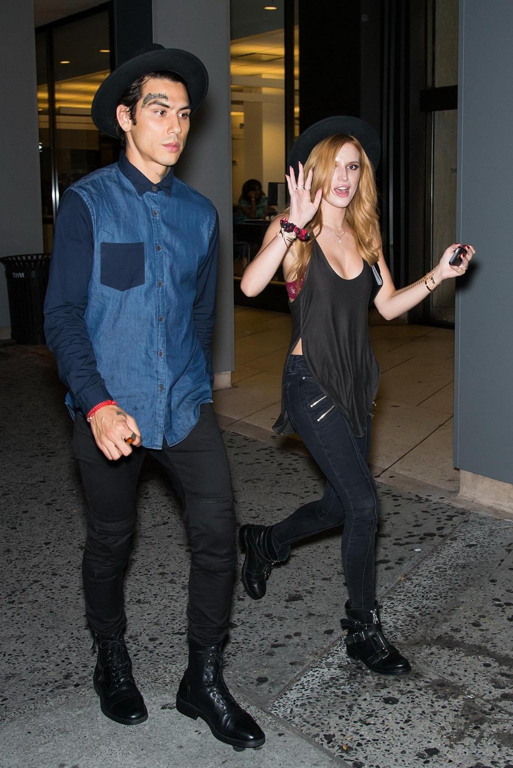 10P Bella Thorne showing big cleavage in a black top and tight jeans out in NYC
