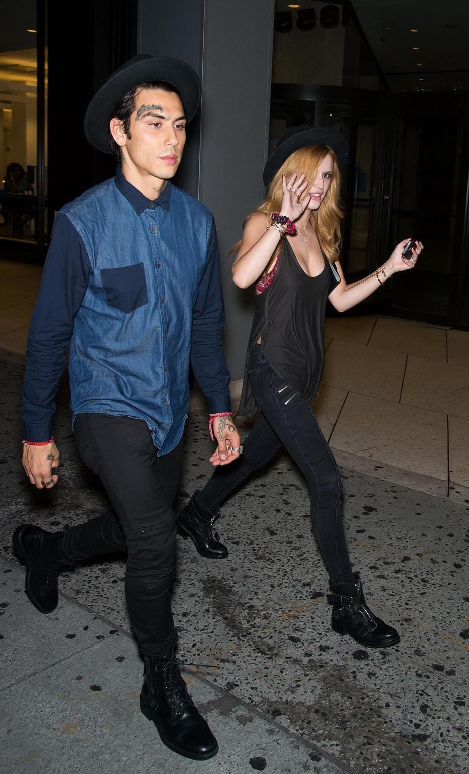 10P Bella Thorne showing big cleavage in a black top and tight jeans out in NYC