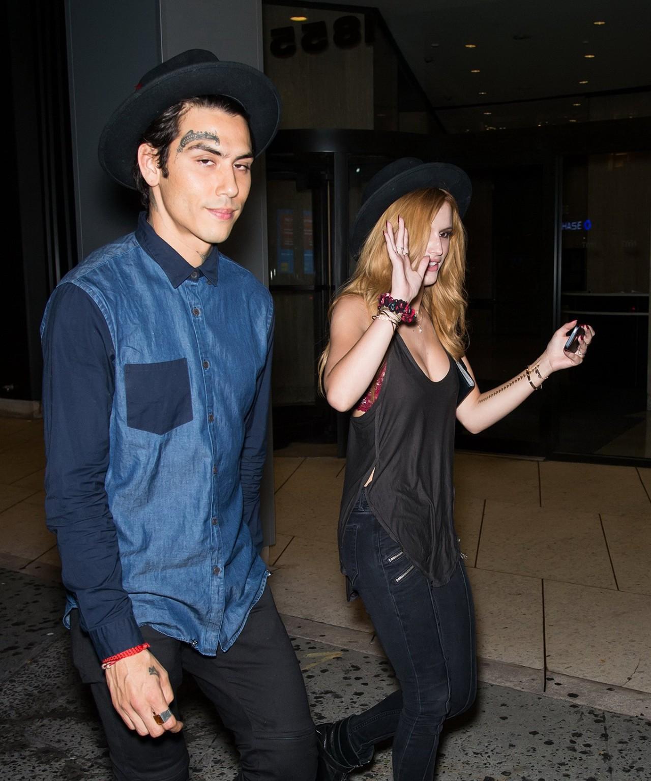 10P Bella Thorne showing big cleavage in a black top and tight jeans out in NYC