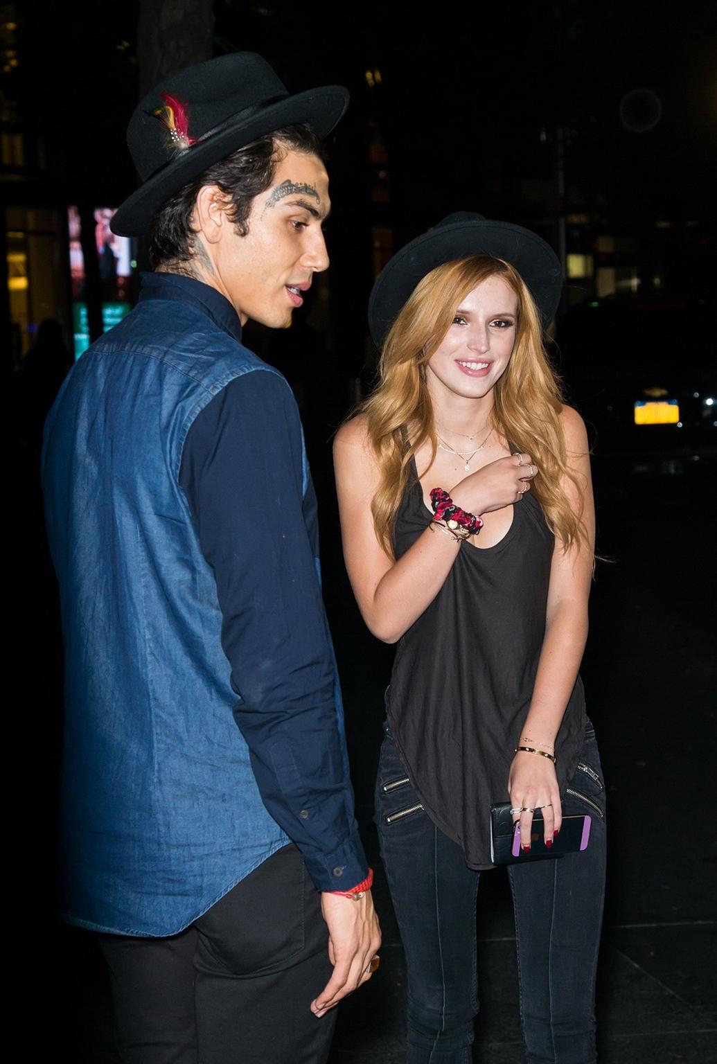 10P Bella Thorne showing big cleavage in a black top and tight jeans out in NYC