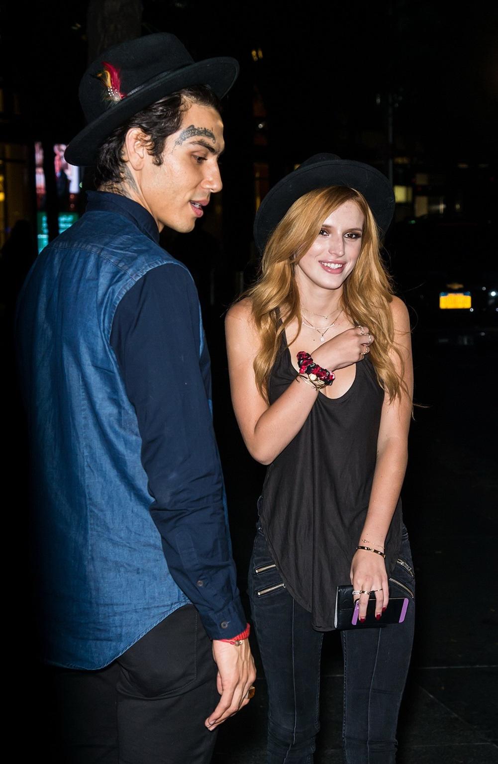 10P Bella Thorne showing big cleavage in a black top and tight jeans out in NYC