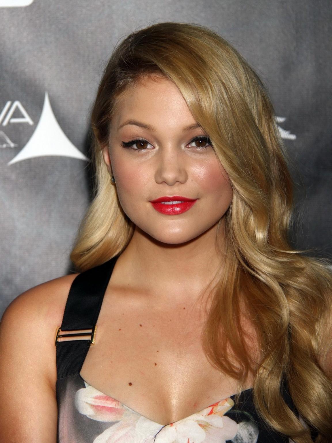 16P Olivia Holt showing big cleavage in a tight floral dress for the Industry Dance 