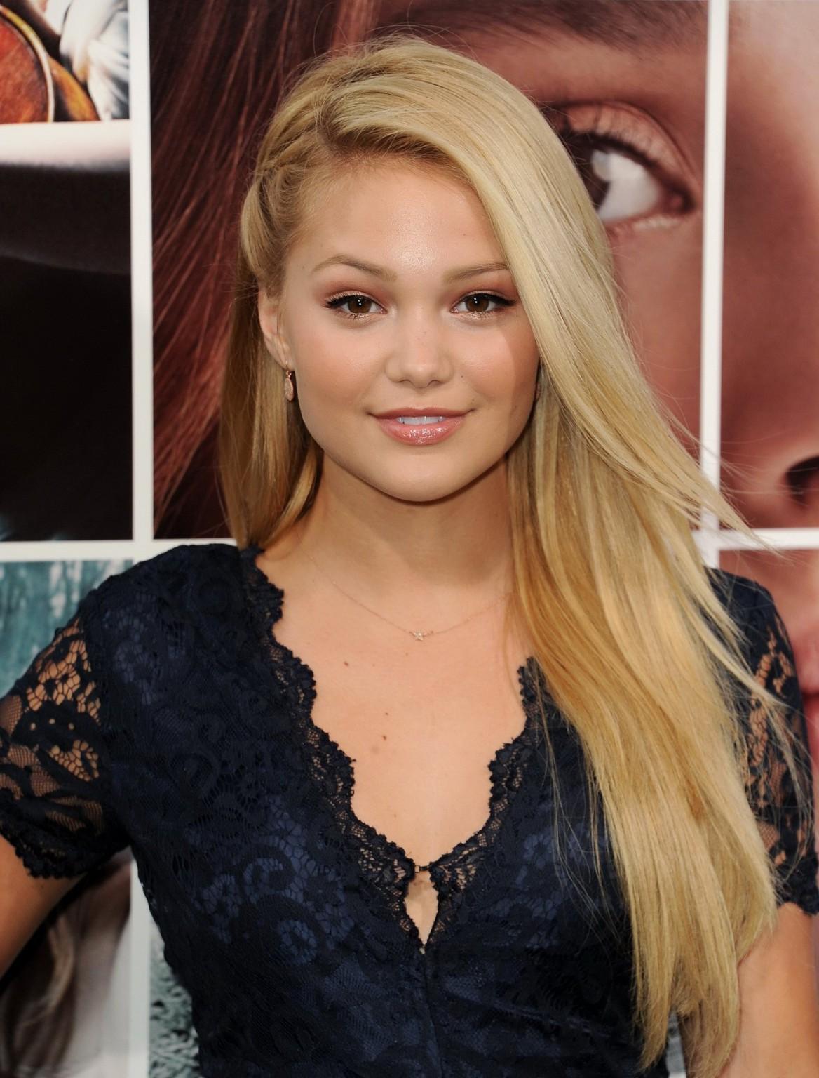 16P Olivia Holt cleavy and leggy in a blue lace mini dress at If I Stay premiere in 
