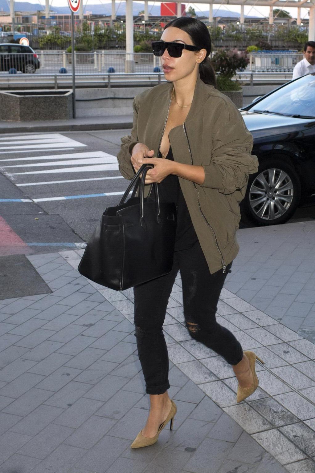 16P Kim Kardashian showing huge cleavage at Nice Airport in France